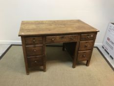 An early to mid 20th Century oak double pedestal desk with central slim drawer flanked by two