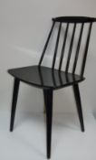 A set of eight mid 20th Century Danish ebonised stick back chairs with panel seats on turned legs,