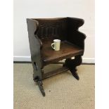 A 20th Century oak chair in the 17th Century style, the back with linen fold decoration above a