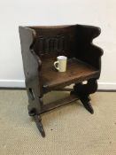 A 20th Century oak chair in the 17th Century style, the back with linen fold decoration above a