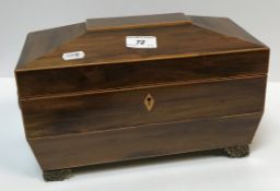 An early 19th Century rosewood veneered and satinwood strung tea caddy of sarcophagus form, the