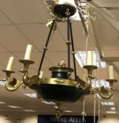 A brass and black painted metal six branch electrolier in the Empire style with swan decoration to