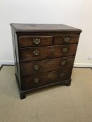 A late 18th Century North Country oak and cross-banded chest, the top with moulded edge over two