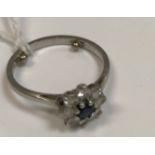 A platinum diamond and sapphire set flower head cluster ring (Provenance: Mappin & Webb), size J/I