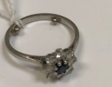 A platinum diamond and sapphire set flower head cluster ring (Provenance: Mappin & Webb), size J/I