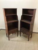 A pair of circa 1900 mahogany open bookcases of waterfall form, the plain tops with beaded edge over