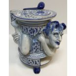 A 20th Century Delft blue and white tobacco jar with high relief decoration of the Devil, within the