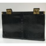 A vintage Jane Shilton black dyed snakeskin handbag with brass clips, 31 cm wide x 20 cm high (not