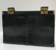 A vintage Jane Shilton black dyed snakeskin handbag with brass clips, 31 cm wide x 20 cm high (not