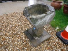 A composite stone bird bath / garden urn raised on square tapering base, approx 36 cm x 36 cm x 53