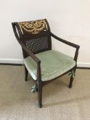 A 20th Century mahogany and gold painted caned elbow chair with open arms on square supports in