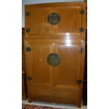 A modern Chinese elm wardrobe with two cupboard doors over two further cupboard doors enclosing