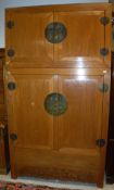 A modern Chinese elm wardrobe with two cupboard doors over two further cupboard doors enclosing