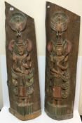 A pair of 20th Century Thai carved and painted teak figure panels with peacock decoration over a