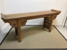 A Chinese elm altar table, the top with scroll ends above a cloud carved frieze on square supports