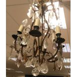 A 20th Century six branch coppered wrought iron framed electrolier with ornate glass drop