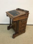 A Victorian walnut and inlaid Davenport desk, the three quarter galleried fretwork top above a