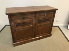 A Victorian oak sideboard with plain top over two drawers and two oak leaf and acorn / ivy carved