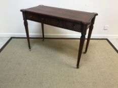 A mahogany three drawer side table in the Victorian manner, raised on reeded and fluted tapering