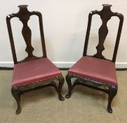 A pair of 18th Century walnut framed low chairs with scroll carved top rail and vase shaped back