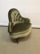 A Victorian buttoned upholstered corner salon chair on squat cabriole legs to scroll feet and