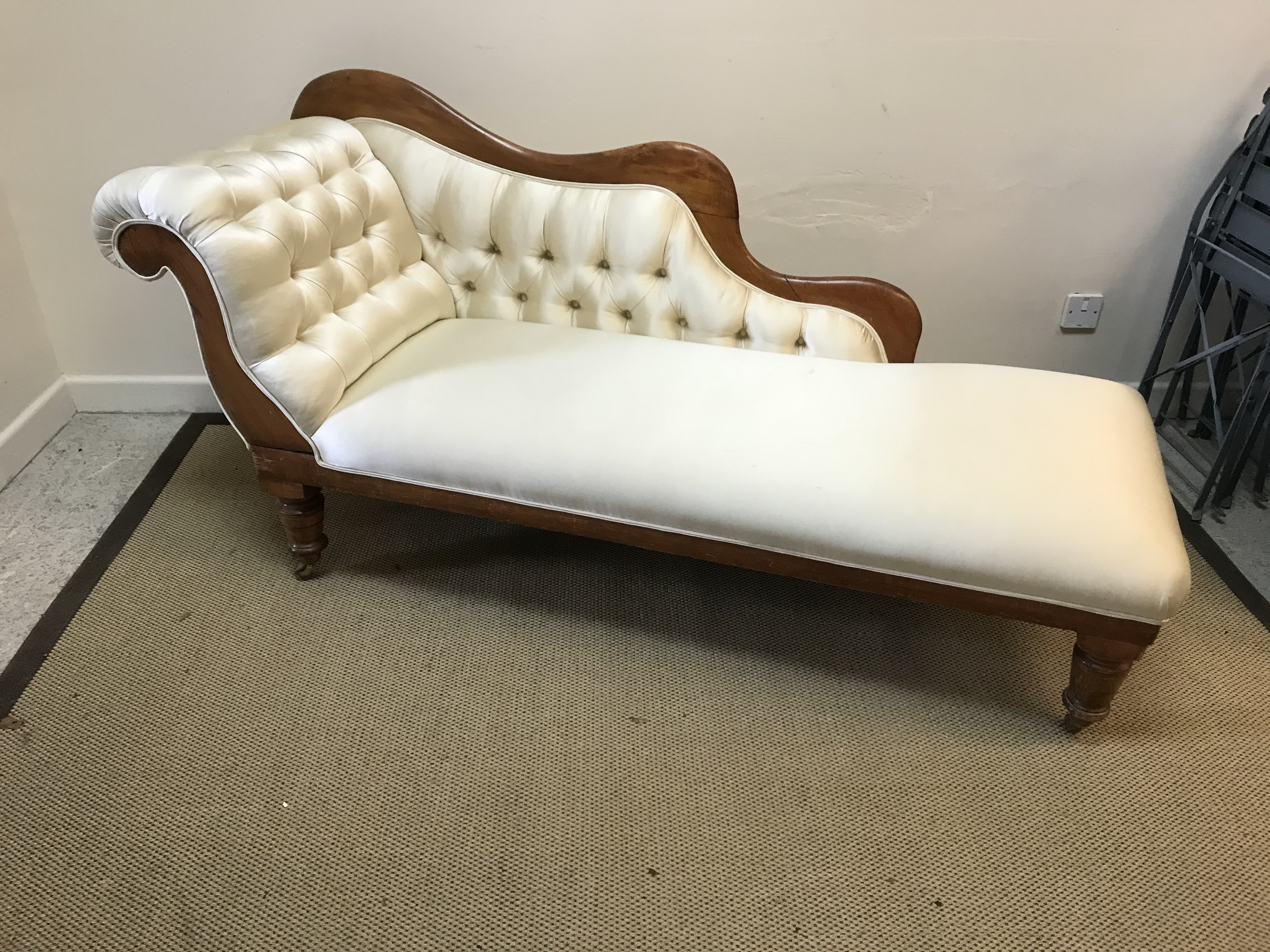 A Victorian satin walnut framed chaise longue with buttoned cream silk upholstery, approx 175 cm