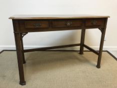 A modern mahogany and ash cross-banded three drawer side table in the Chippendale taste on blind
