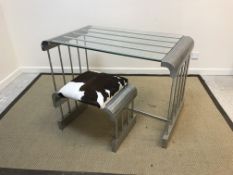A mid to late 20th Century aluminium rod constructed glass top table with curved single piece ends