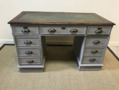 A 20th Century double pedestal desk, the tooled and gilded leather insert mahogany framed top on a