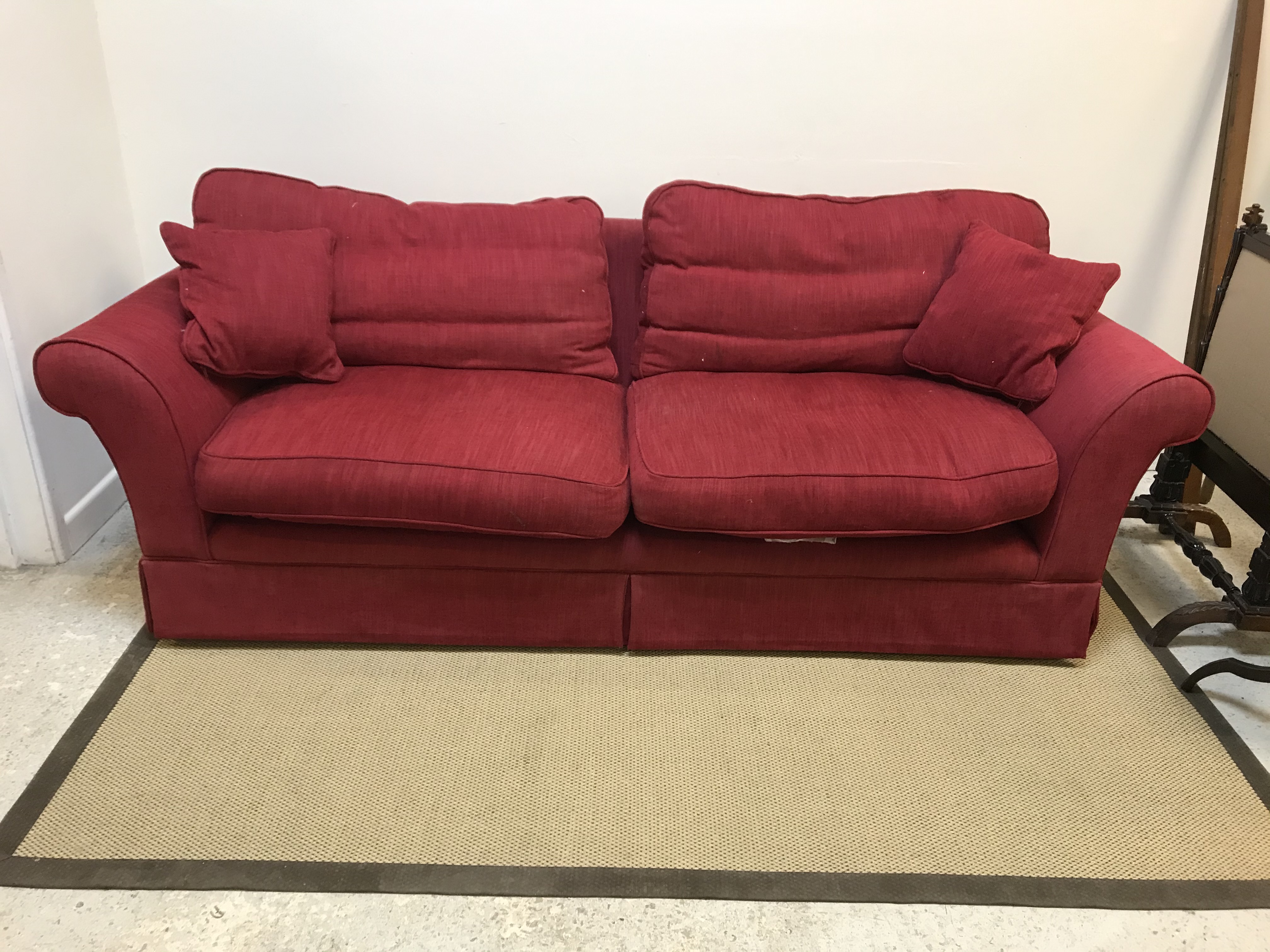A modern red upholstered two seat sofa, 220 cm wide x 90 cm deep x 80 cm high