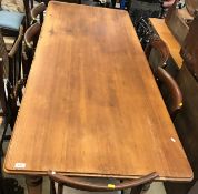 A 20th Century pitch pine farmhouse kitchen table, the top with moulded edge above a plain frieze on