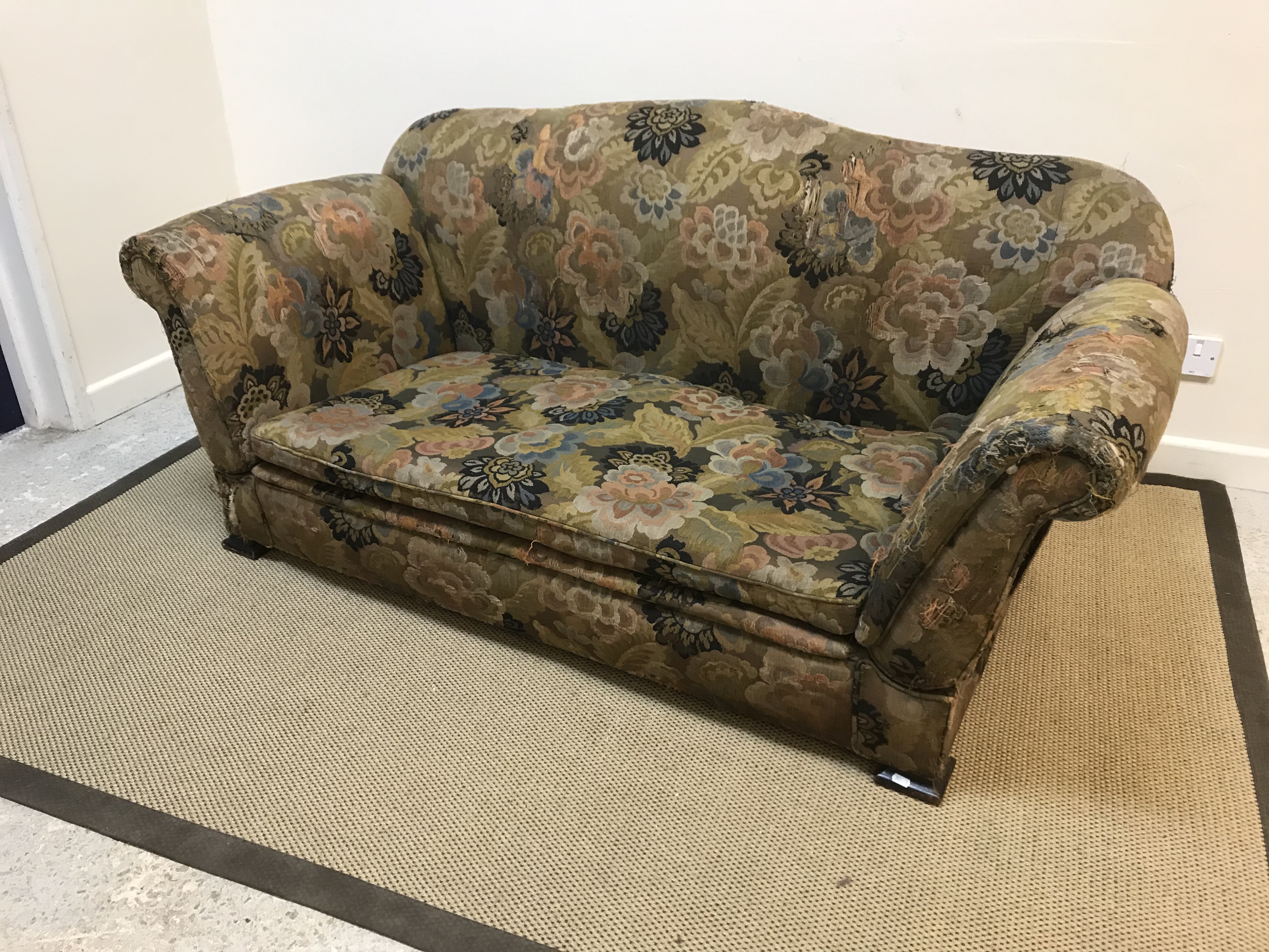 An early 20th Century floral upholstered double drop arm two seat sofa on squat square feet, 168
