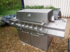 A large Swiss Grill gas barbecue with cover