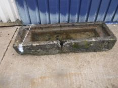 A natural stone trough of rectangular form with pouring spout to long edge, 116 cm long x 38 cm deep