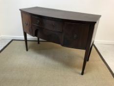 An Edwardian mahogany bow fronted sideboard, the plain top with cross-banded edging over two central