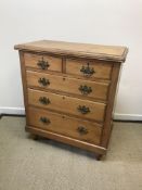 A circa 1900 pitch pine chest of two short over three long drawers with brass swan neck handles,