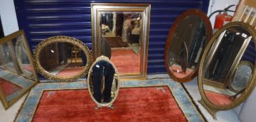 A circa 1900 oval gilt framed easel mirror, 61 cm wide x 77 cm high, together with an early 20th