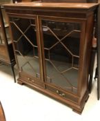WITHDRAWN An Edwardian mahogany display cabinet, the plain top above a carved and beaded frieze
