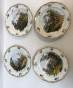 A set of four Meissen "Stag hunting" plates, each depicting hunting scenes, hand-painted within a