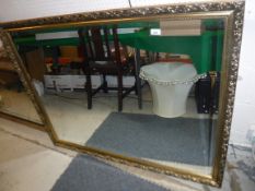 A modern gilt decorated rectangular wall mirror with bevelled plate, approx 127 cm x 100 cm