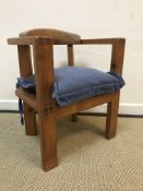 A modern Arts & Crafts style pine child's chair with yoke back and visible dovetails on