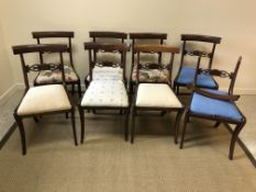 A set of eight Victorian mahogany bar back dining chairs with drop-in seats on sabre supports (