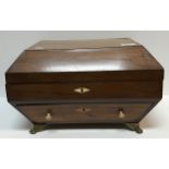 A late Georgian mahogany work box of sarcophagus form, the rising top over a single drawer on