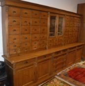 A 19th Century Austro-Hungarian pine apothecary or chemist's cabinet, the upper section with two