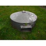 A galvanised chicken heater of circular form