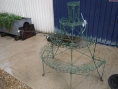 A Victorian painted wirework four tier plant stand of demi-lune form, 134 cm high