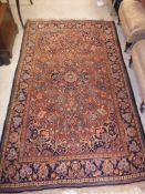 A Kashan rug, the central panel set with floral decorated medallion on a red and blue floral