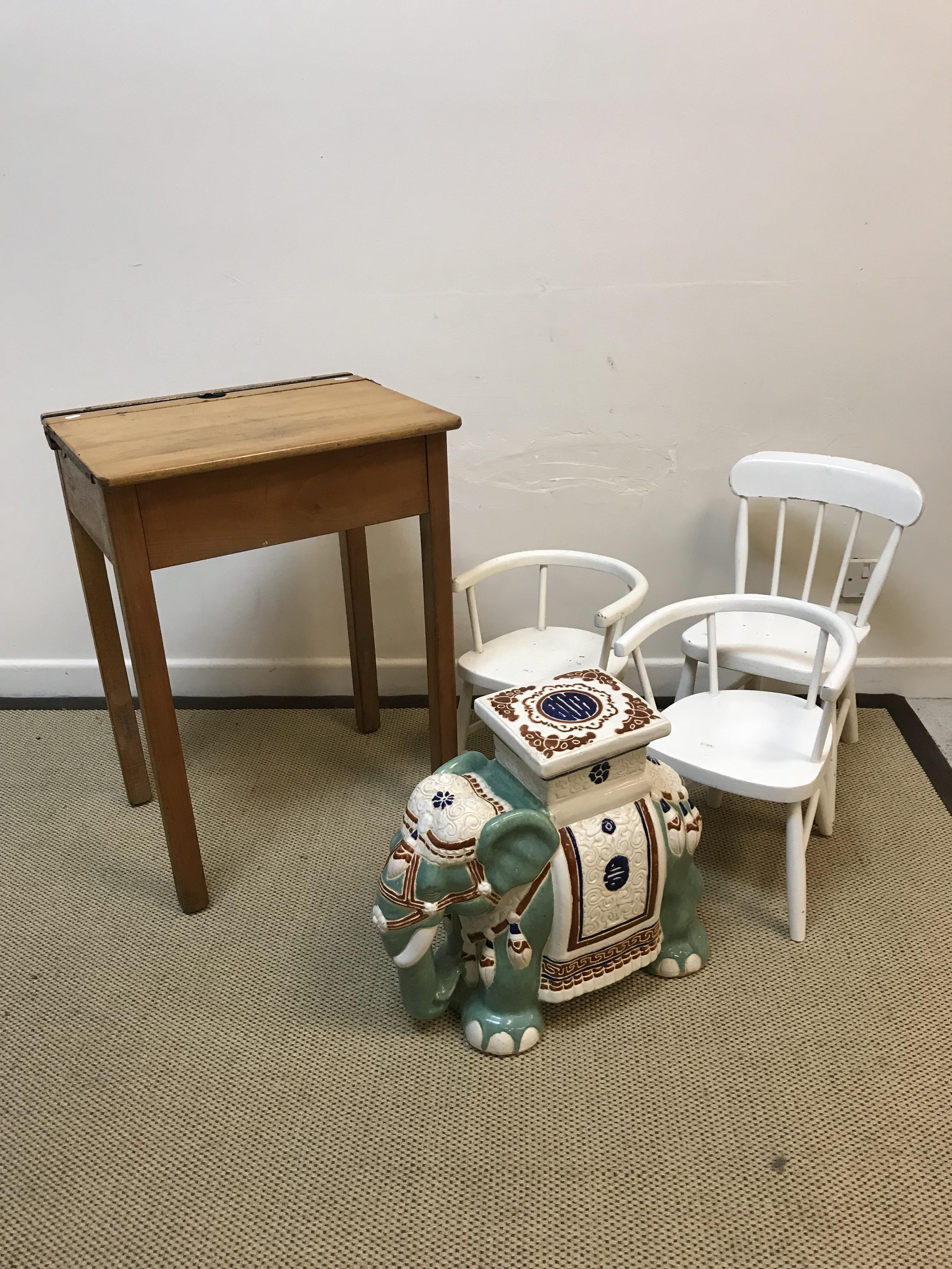 Three child's white painted chairs and a beech school type desk with rising top