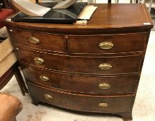 An early 19th Century mahogany bow fronted chest of two short over three long graduated drawers on