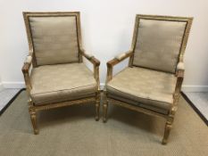 A pair of 19th Century gilt decorated elbow chairs in the Louis XV taste with upholstered backs,